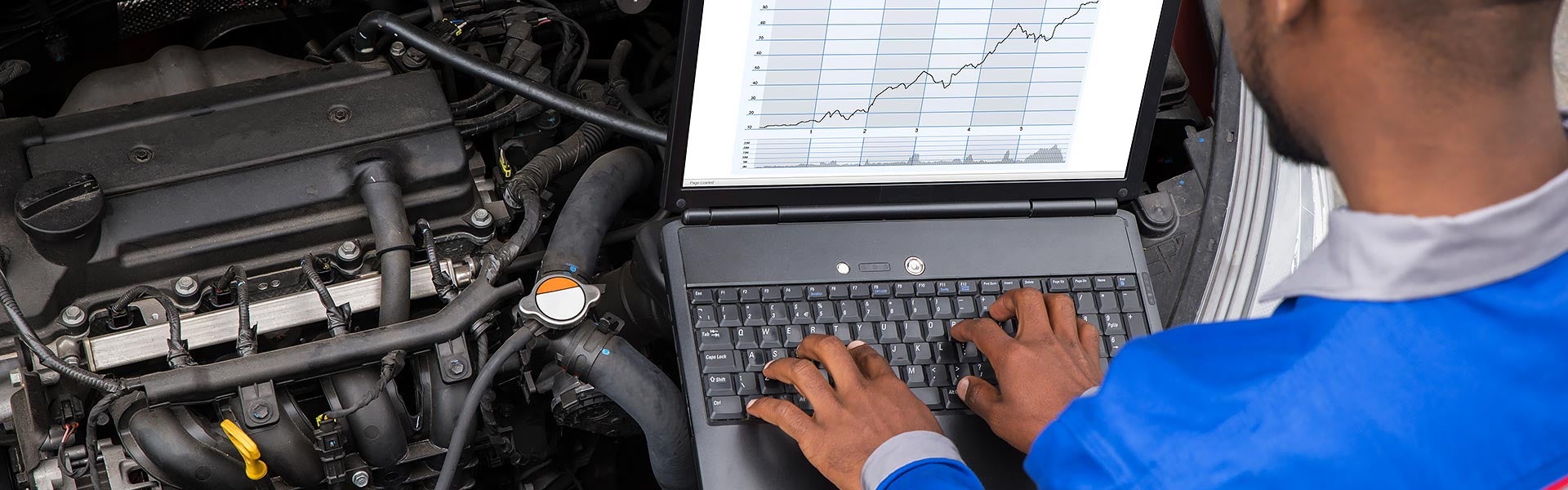 Service technician diagnosing an engine