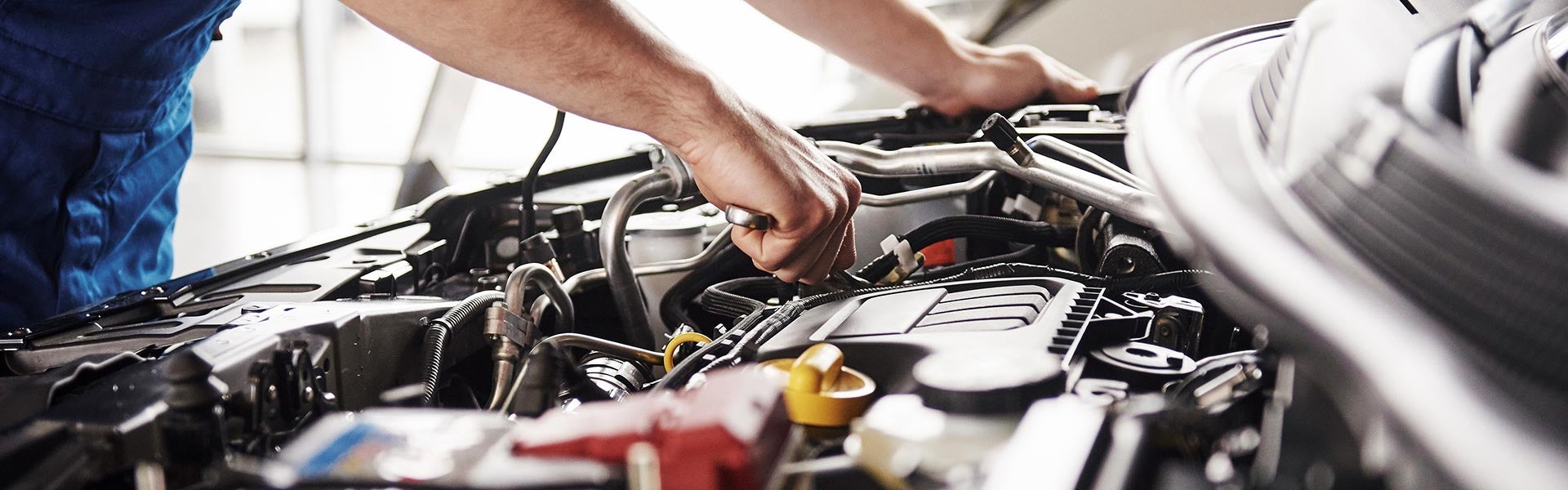 Service technician checking car's engine